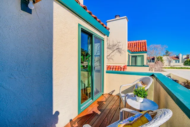 a balcony with furniture and a potted plant