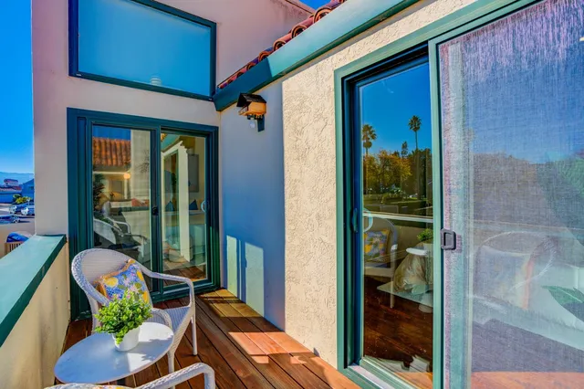 a balcony with furniture and a potted plant