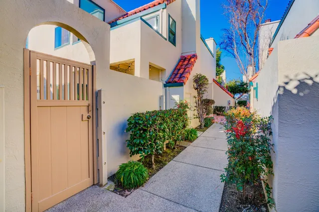 an aerial view of a house with a yard and potted plants