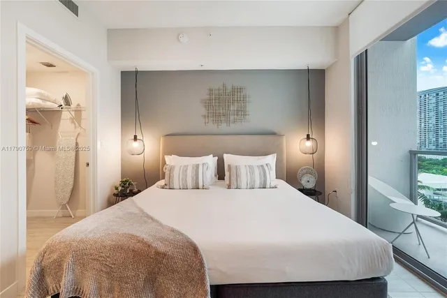 a bedroom with a bed and a mirror