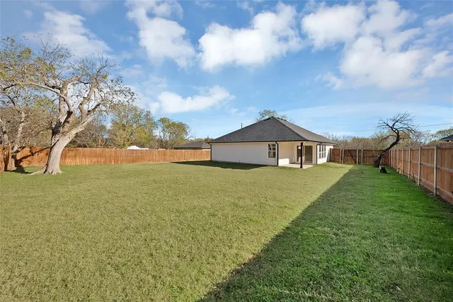 a front view of a house with yard and green space