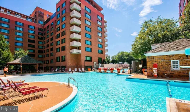 a backyard of a building with barbeque oven table and chairs