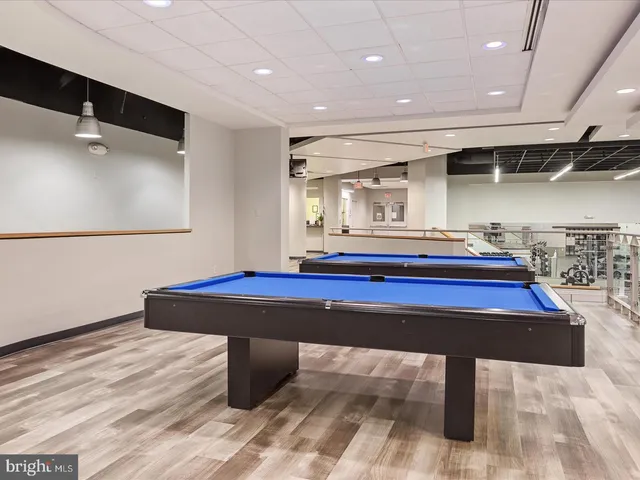 a room with pool table and windows