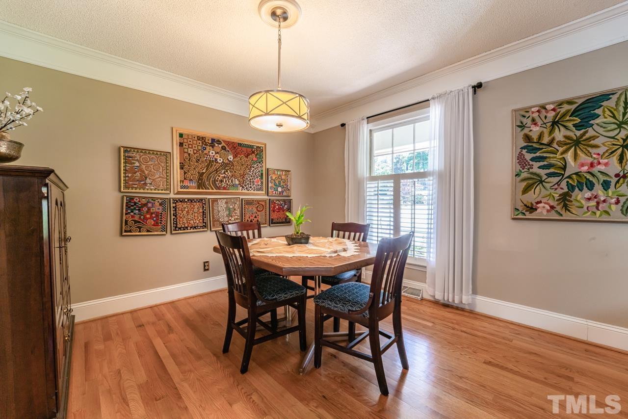 3318 Hampton Road Raleigh, NC 27607 - Photo 18 of 56 a view of a dining room with furniture wooden floor and a chandelier