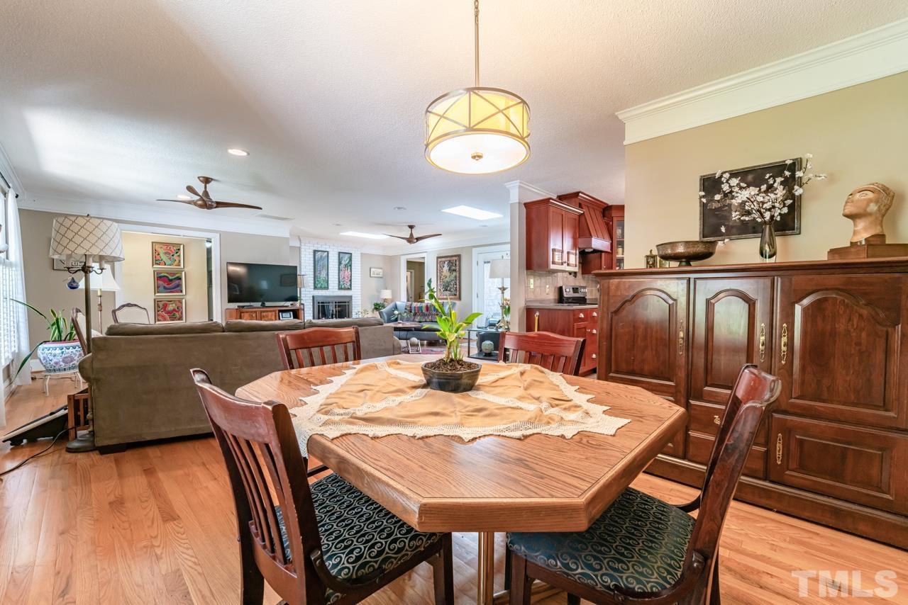 3318 Hampton Road Raleigh, NC 27607 - Photo 19 of 56 a view of a dining room with furniture a kitchen and chandelier