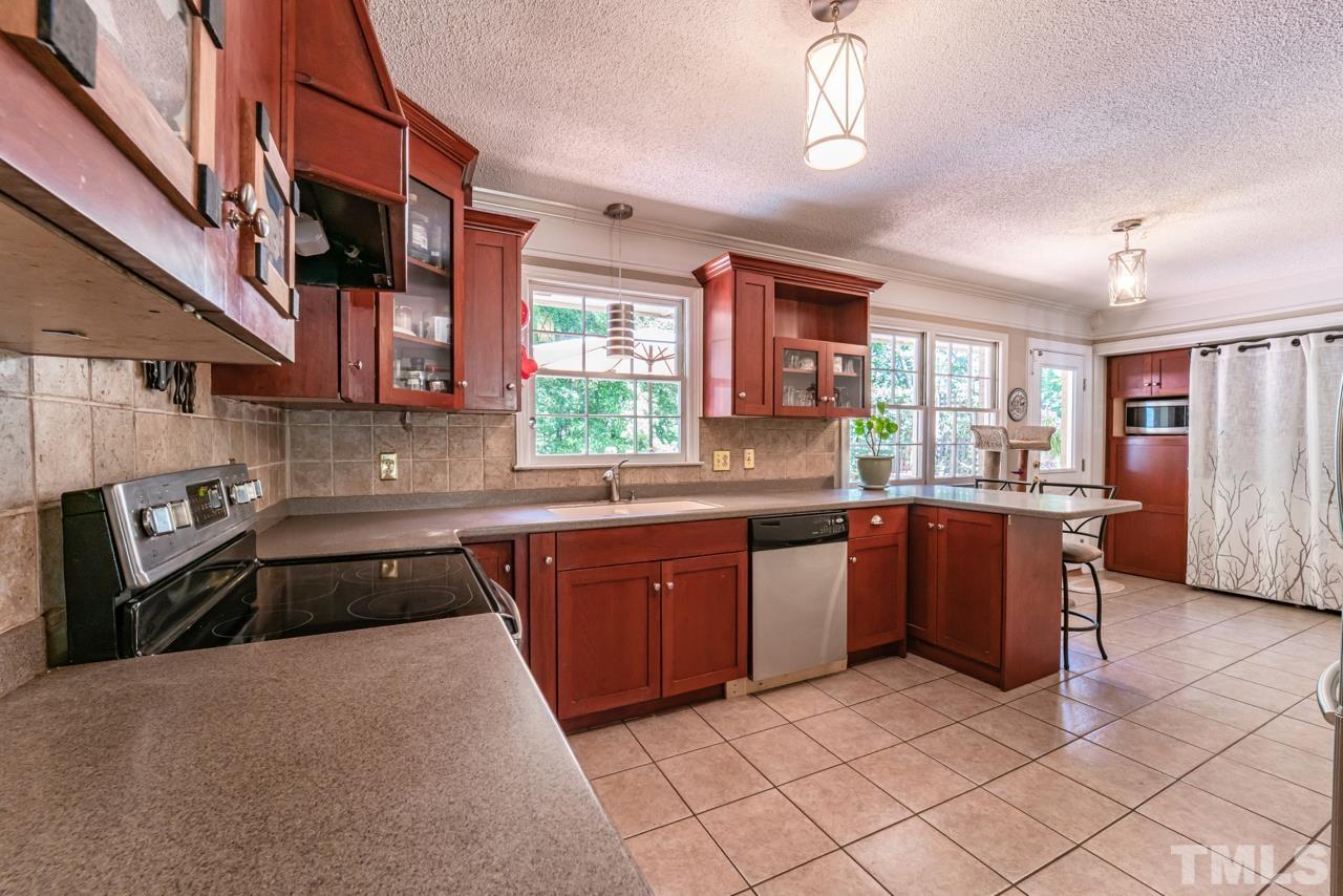 3318 Hampton Road Raleigh, NC 27607 - Photo 21 of 56 a kitchen with stainless steel appliances granite countertop a sink and stove