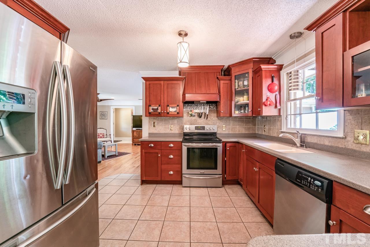 3318 Hampton Road Raleigh, NC 27607 - Photo 22 of 56 a kitchen with stainless steel appliances granite countertop a refrigerator and a sink