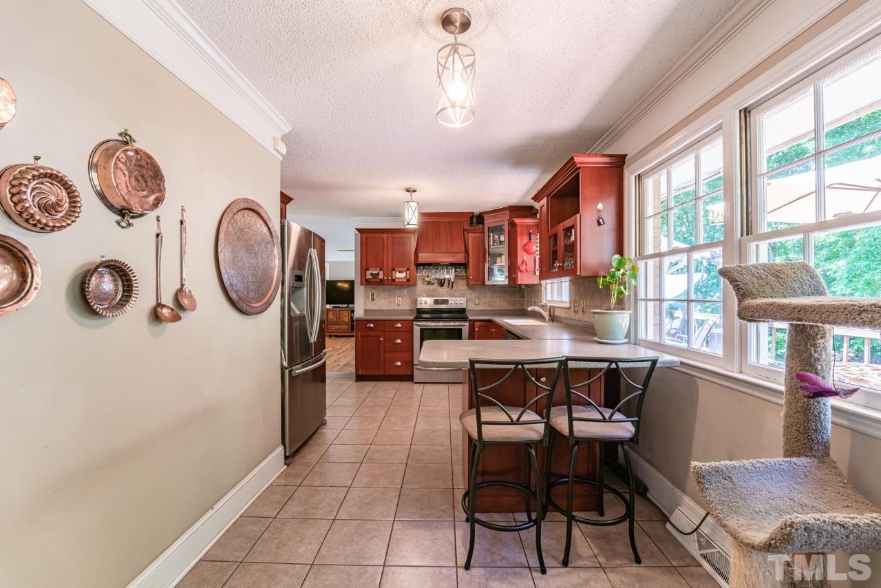 3318 Hampton Road Raleigh, NC 27607 - Photo 23 of 56 a view of a dining room with furniture window and wooden floor