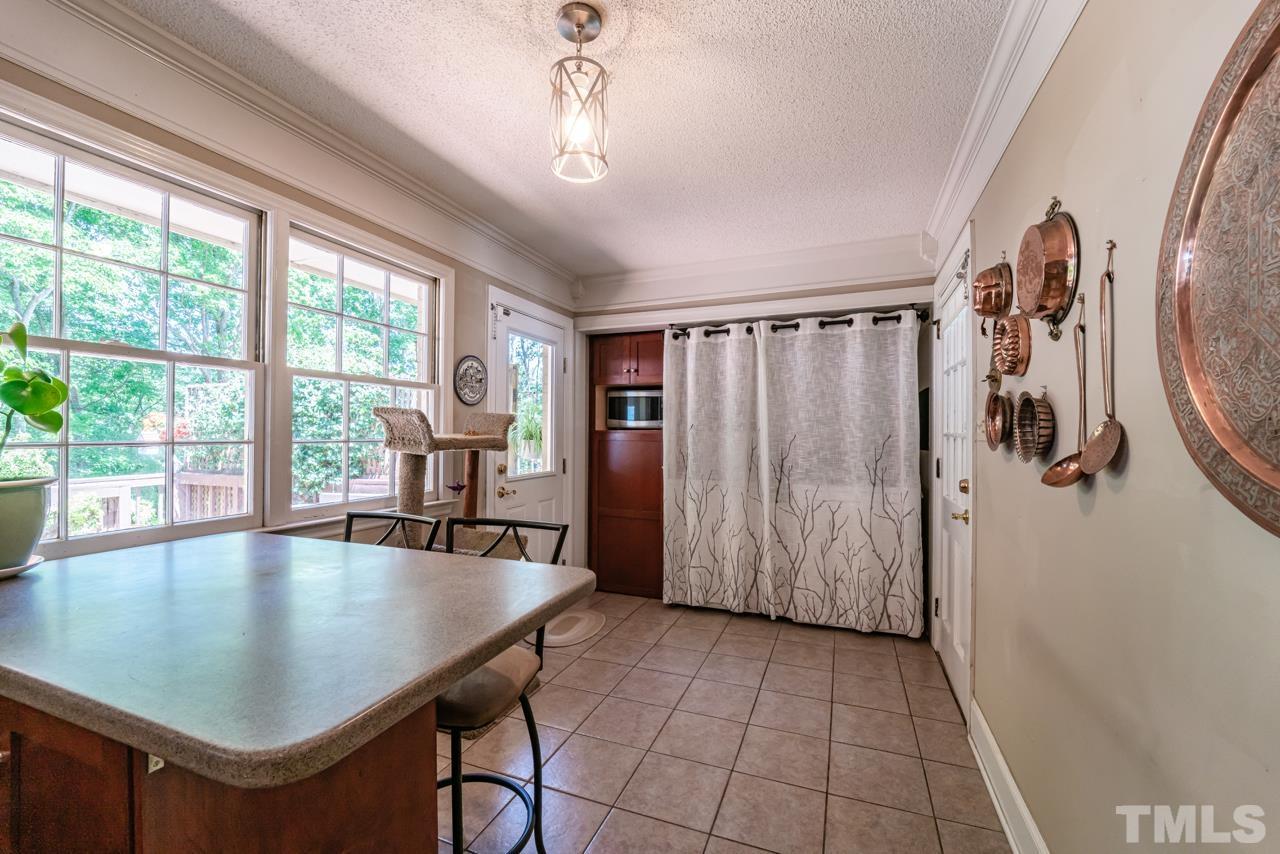 3318 Hampton Road Raleigh, NC 27607 - Photo 24 of 56 a view of a dining room with furniture window and outside view
