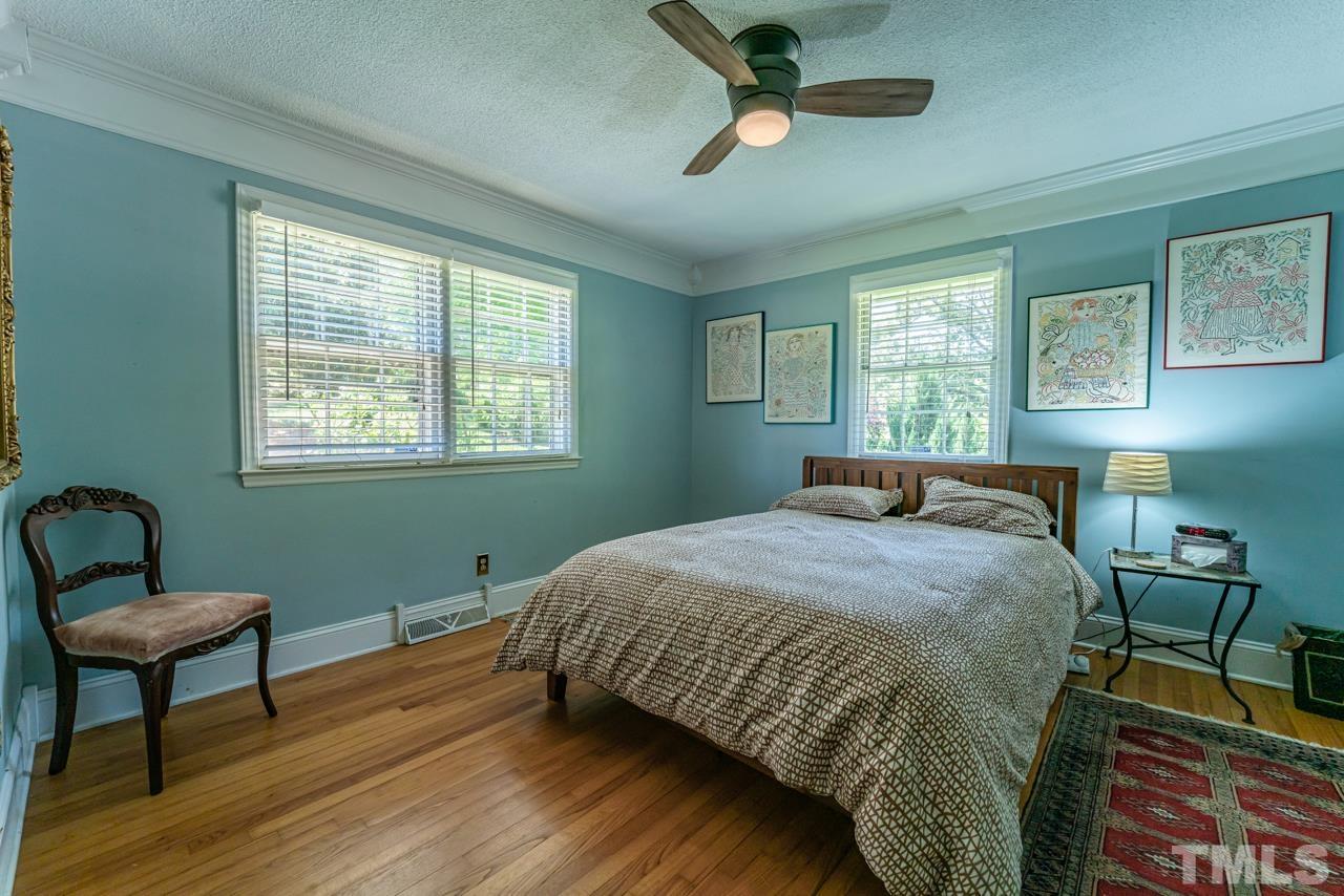 3318 Hampton Road Raleigh, NC 27607 - Photo 26 of 56 a bedroom with a bed wooden floor and a window