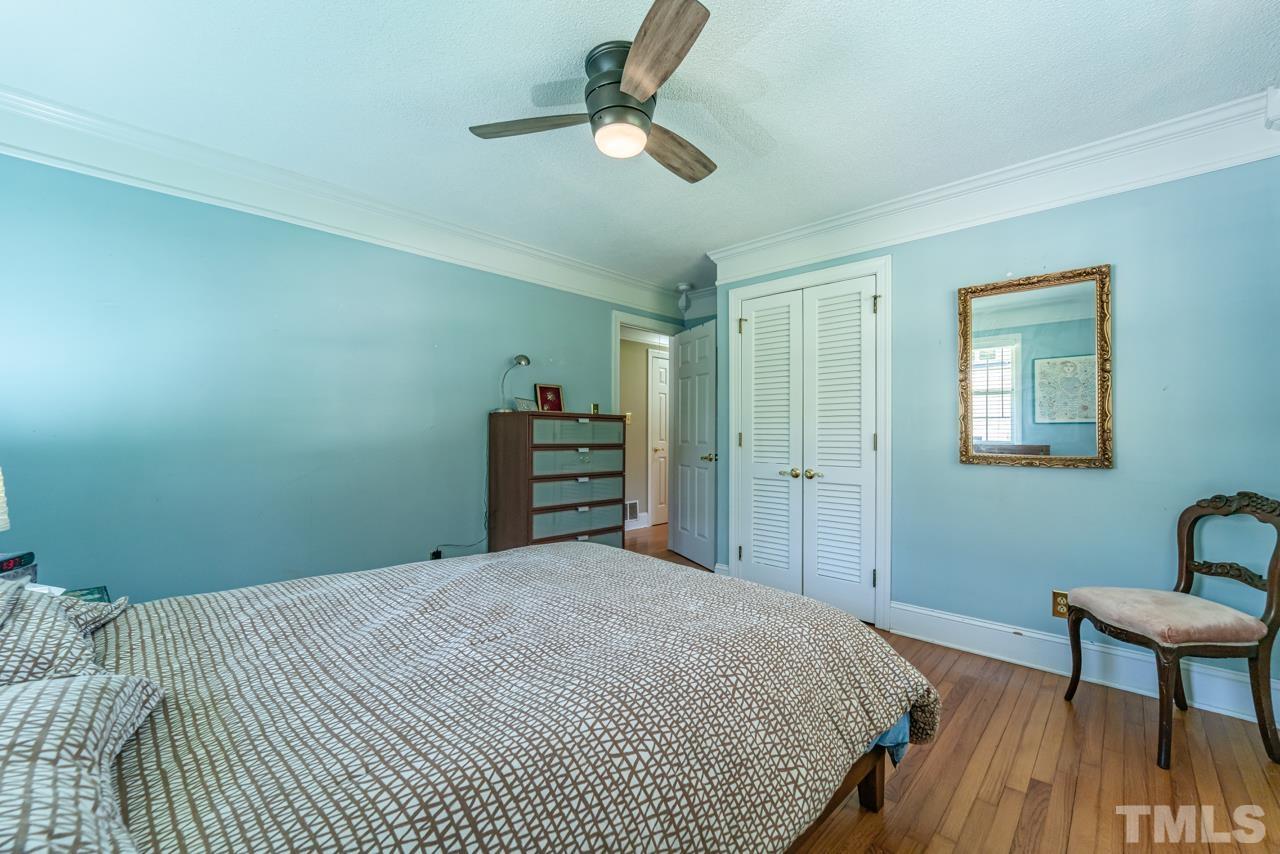 3318 Hampton Road Raleigh, NC 27607 - Photo 28 of 56 a bedroom with a bed and a chair