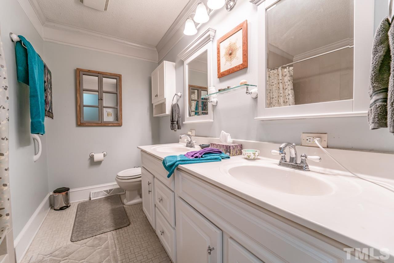 3318 Hampton Road Raleigh, NC 27607 - Photo 31 of 56 a bathroom with a sink a toilet and mirror