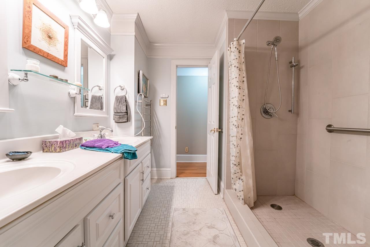 3318 Hampton Road Raleigh, NC 27607 - Photo 33 of 56 a bathroom with a sink vanity granite shower and a mirror