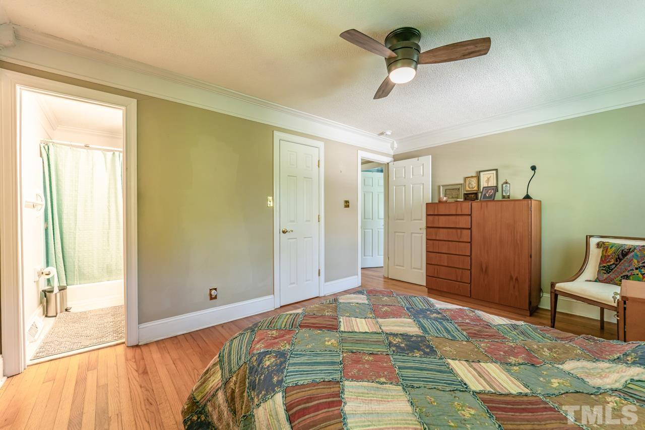 3318 Hampton Road Raleigh, NC 27607 - Photo 34 of 56 a bedroom with a bed and a chandelier