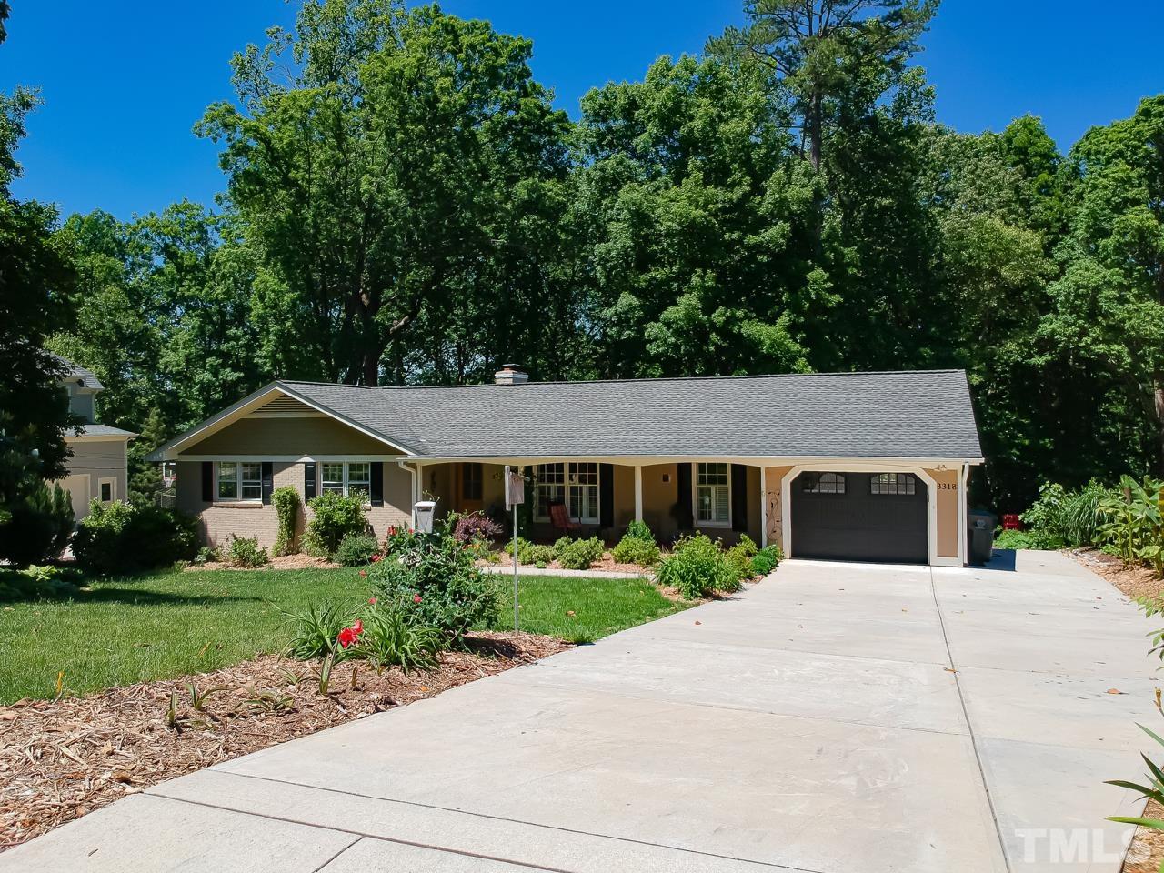 3318 Hampton Road Raleigh, NC 27607 - Photo 5 of 56 a front view of a house with a yard and potted plants