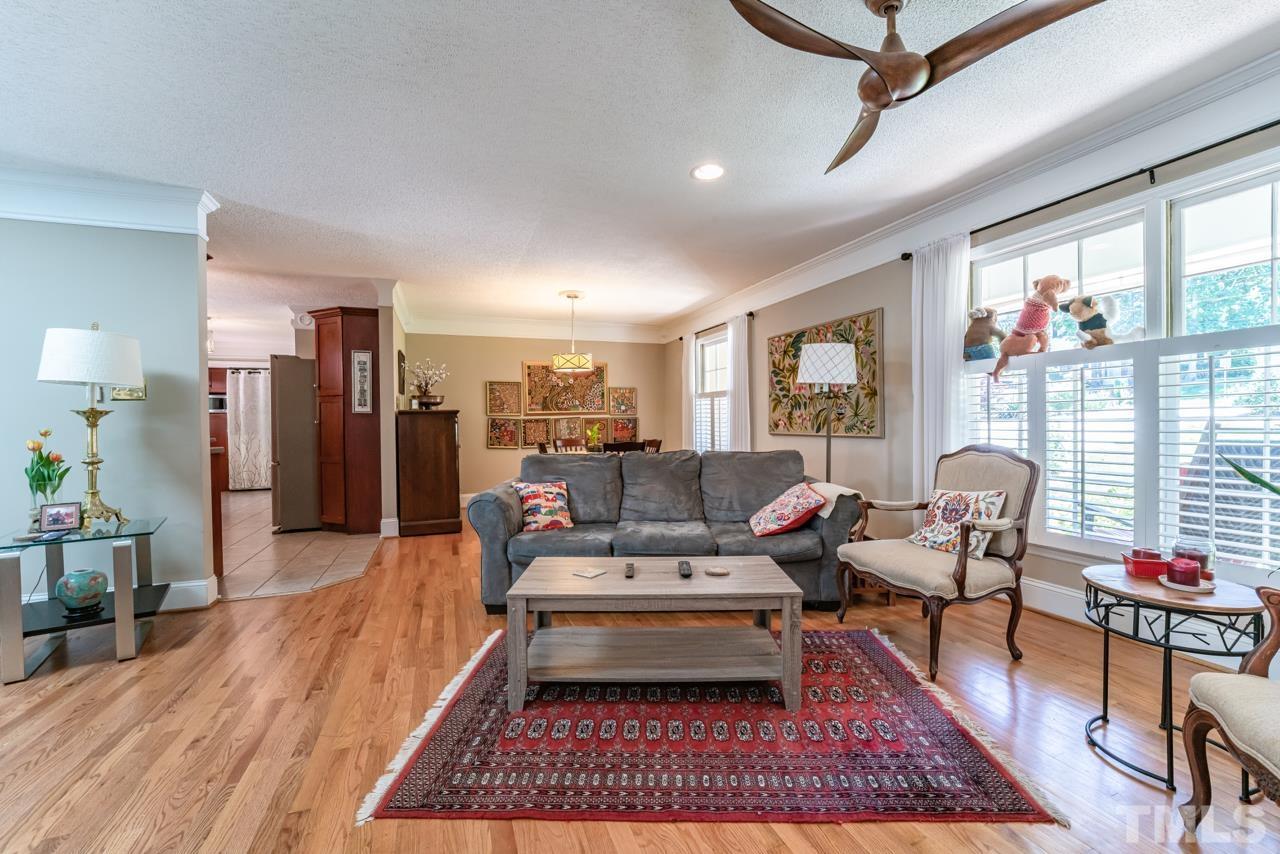 3318 Hampton Road Raleigh, NC 27607 - Photo 8 of 56 a living room with furniture a rug and a floor to ceiling window