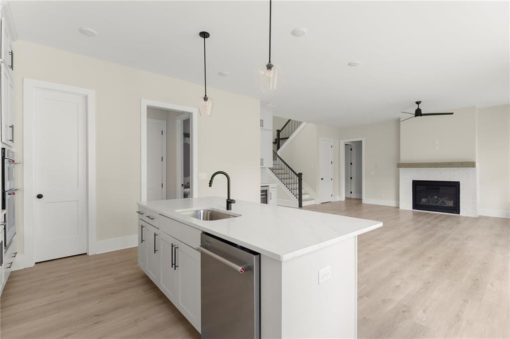 3552 Cedarvale Court Powder Springs, GA 30127 - Photo 13 of 46 a view of a kitchen with a sink and a fireplace