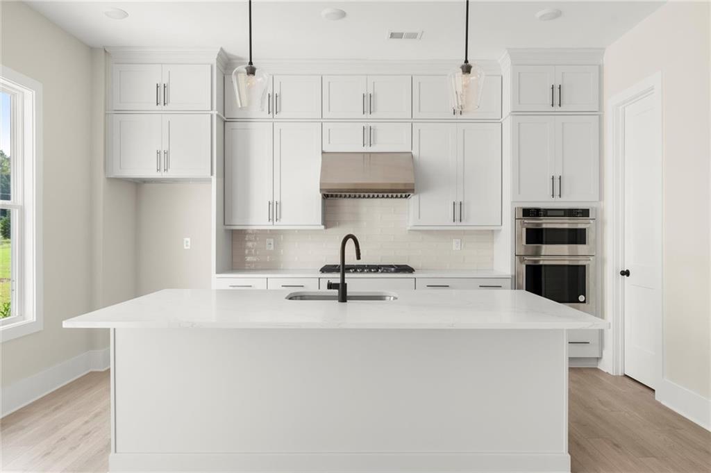 3552 Cedarvale Court Powder Springs, GA 30127 - Photo 15 of 46 a kitchen with stainless steel appliances a refrigerator sink and white cabinets