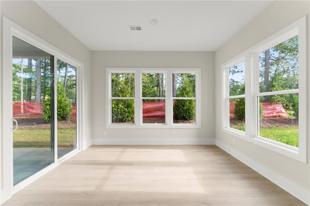 3552 Cedarvale Court Powder Springs, GA 30127 - Photo 17 of 46 a view of an empty room with wooden floor and a window