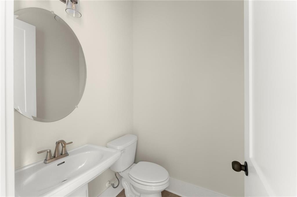 3552 Cedarvale Court Powder Springs, GA 30127 - Photo 19 of 46 a bathroom with a toilet sink and mirror