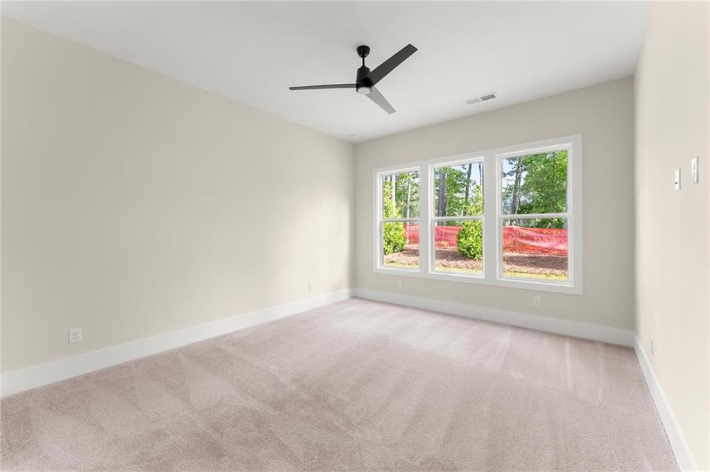 3552 Cedarvale Court Powder Springs, GA 30127 - Photo 21 of 46 a view of empty room with wooden floor and fan