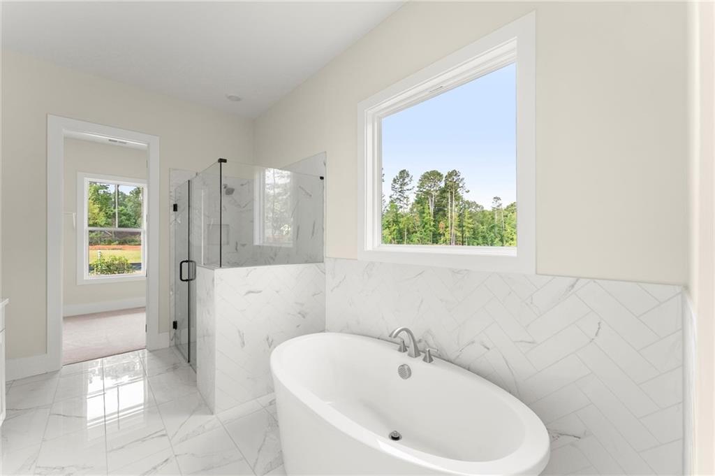 3552 Cedarvale Court Powder Springs, GA 30127 - Photo 24 of 46 a bathroom with a bathtub and a shower