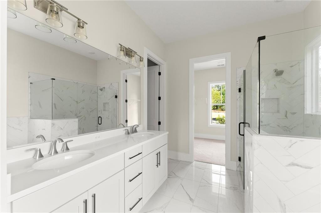 3552 Cedarvale Court Powder Springs, GA 30127 - Photo 25 of 46 a bathroom with a double vanity sink mirror and shower