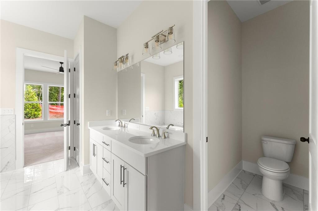 3552 Cedarvale Court Powder Springs, GA 30127 - Photo 27 of 46 a bathroom with a sink and mirror with toilet