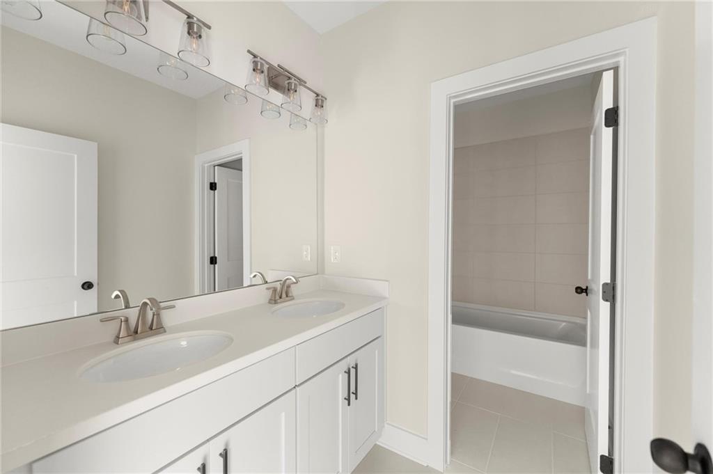 3552 Cedarvale Court Powder Springs, GA 30127 - Photo 37 of 46 a bathroom with a sink double vanity and a mirror