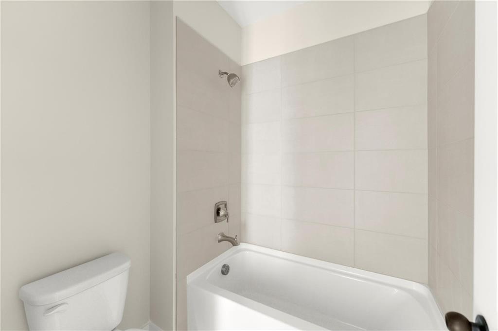 3552 Cedarvale Court Powder Springs, GA 30127 - Photo 38 of 46 a bath tub sitting next to a white toilet and a shower