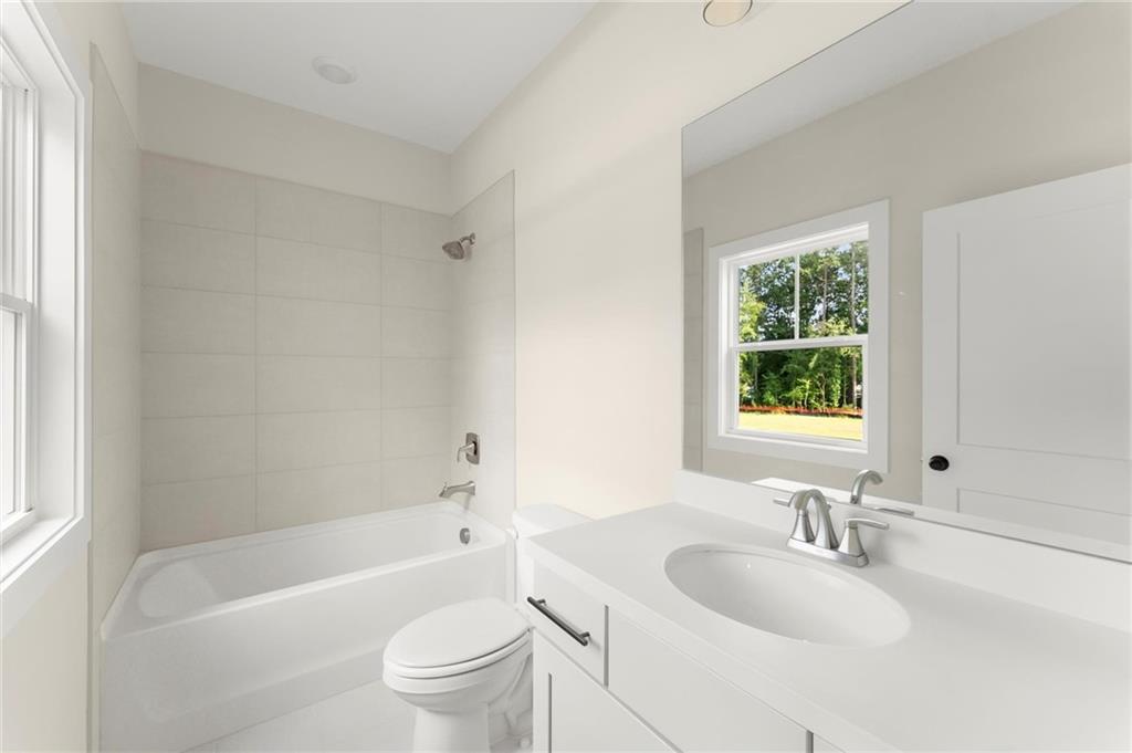 3552 Cedarvale Court Powder Springs, GA 30127 - Photo 41 of 46 a bathroom with a sink toilet bathtub and vanity