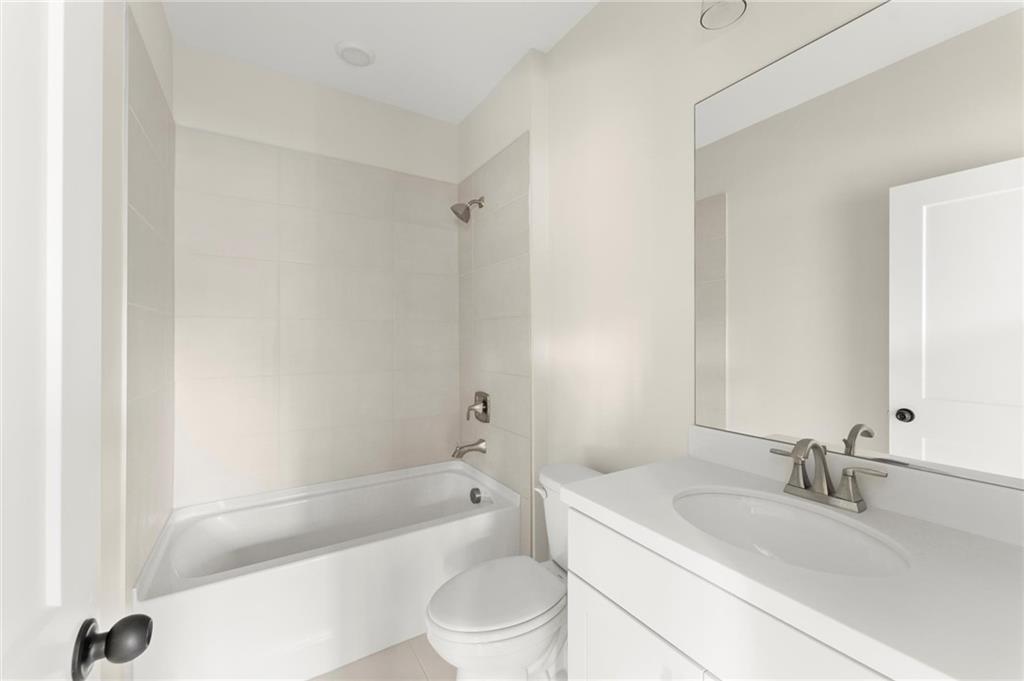 3552 Cedarvale Court Powder Springs, GA 30127 - Photo 44 of 46 a bathroom with a granite countertop sink a toilet and bathtub