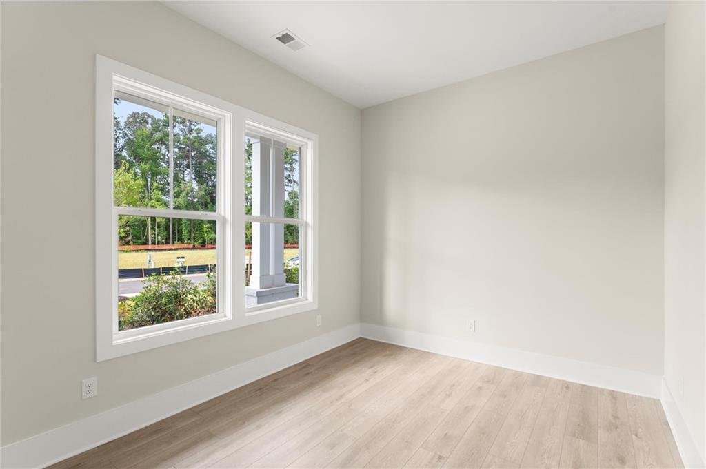 3552 Cedarvale Court Powder Springs, GA 30127 - Photo 5 of 46 a view of an empty room with wooden floor and a window