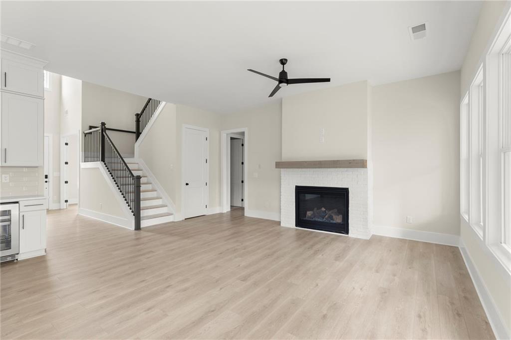 3552 Cedarvale Court Powder Springs, GA 30127 - Photo 9 of 46 a view of an empty room with wooden floor fireplace and a window