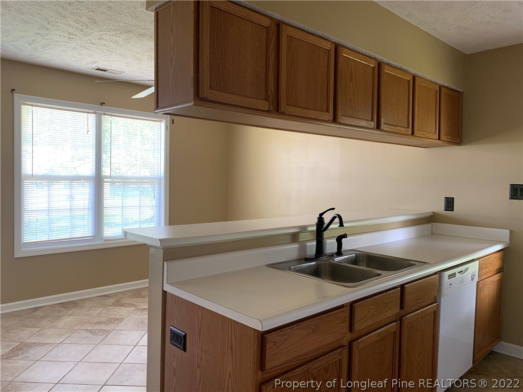 145 Rye Lane Raeford, NC 28376 - Photo 16 of 42 a kitchen with a sink cabinets and window