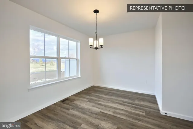a view of a room with wooden floor and windows