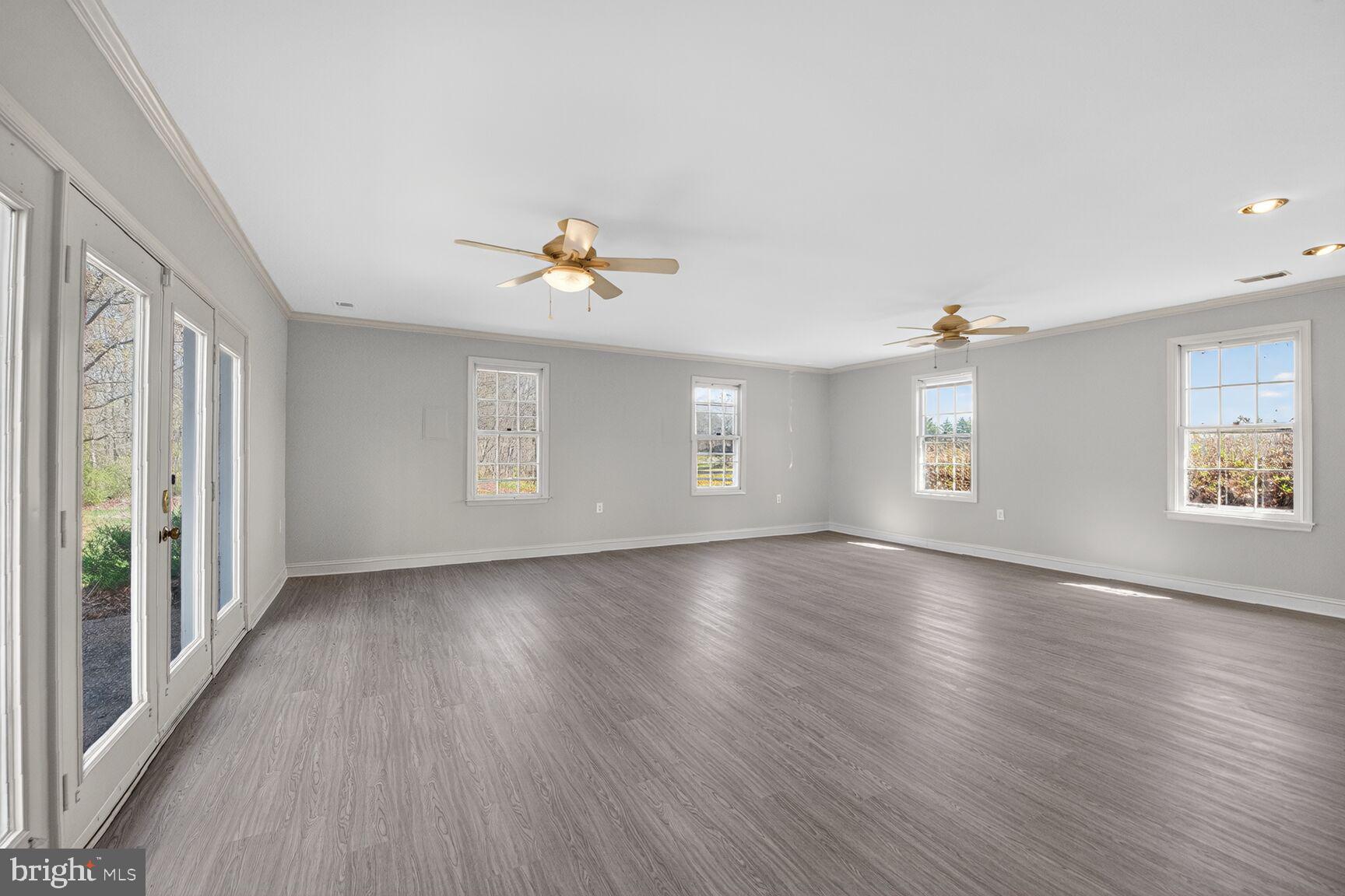 21733 Oatlands Road Aldie, VA 20105 - Photo 13 of 50 an empty room with window and wooden floor