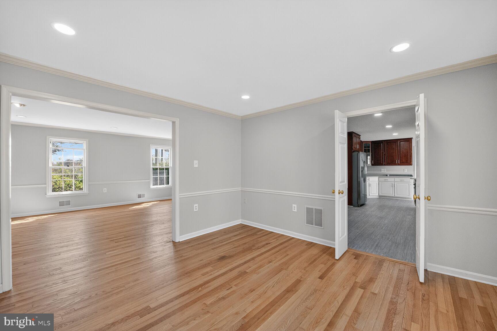 21733 Oatlands Road Aldie, VA 20105 - Photo 15 of 50 an empty room with wooden floor and windows