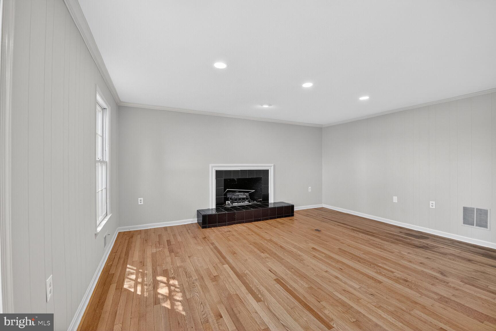 21733 Oatlands Road Aldie, VA 20105 - Photo 17 of 50 a view of empty room with wooden floor and fireplace