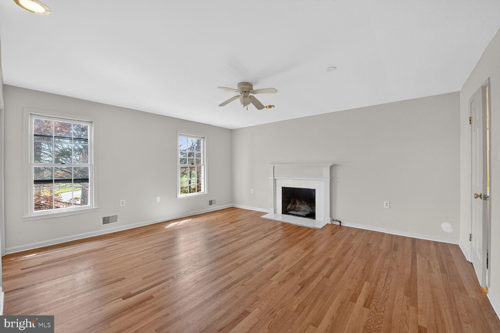 21733 Oatlands Road Aldie, VA 20105 - Photo 19 of 50 an empty room with windows and a fireplace