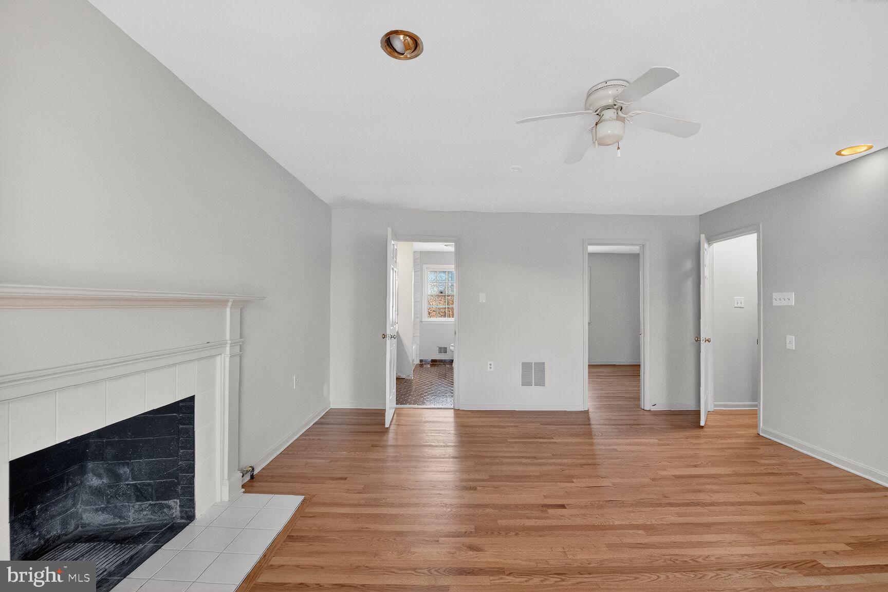 21733 Oatlands Road Aldie, VA 20105 - Photo 21 of 50 a view of a livingroom with wooden floor and a fireplace