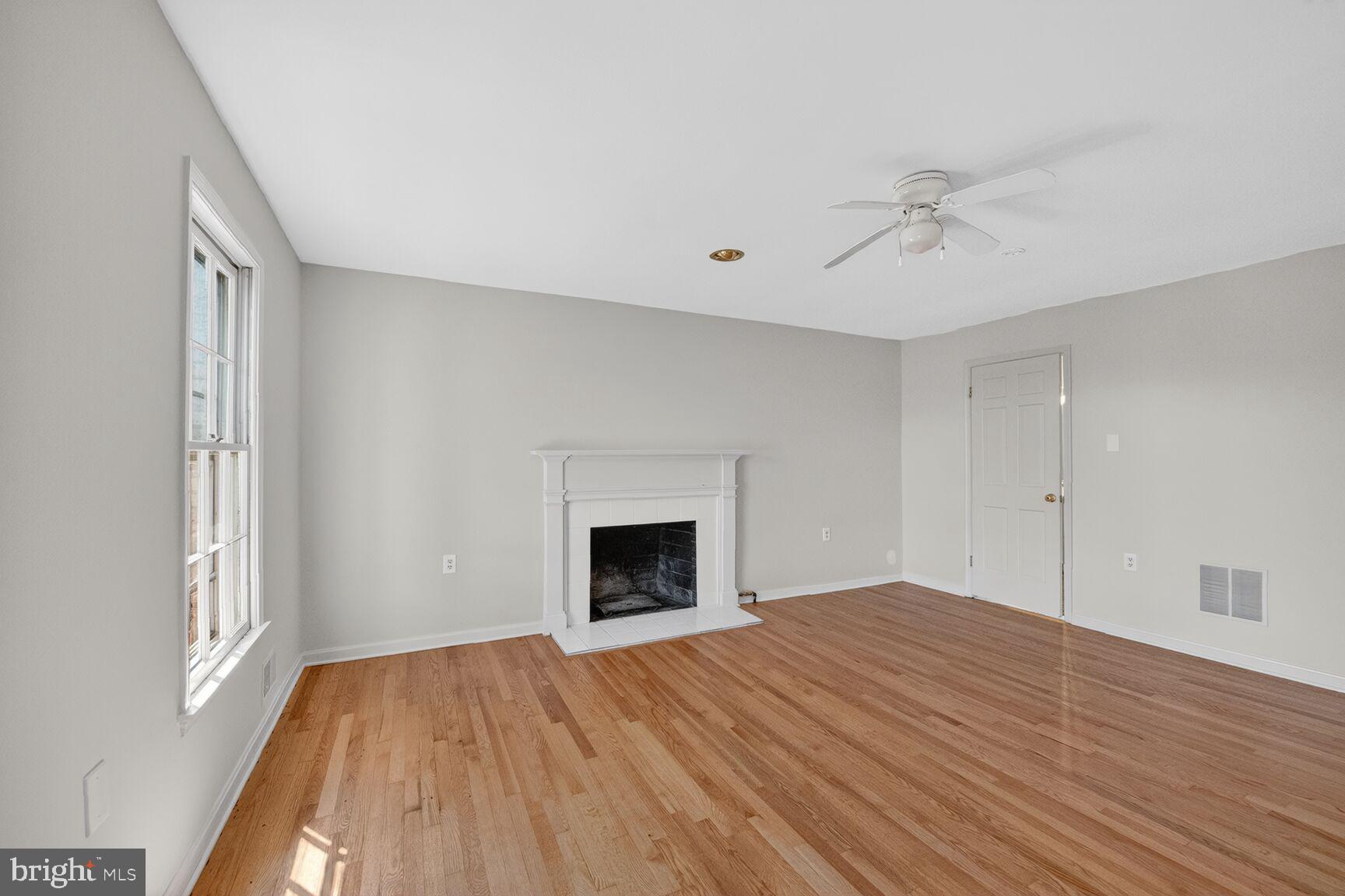 21733 Oatlands Road Aldie, VA 20105 - Photo 22 of 50 a view of empty room with wooden floor and fireplace