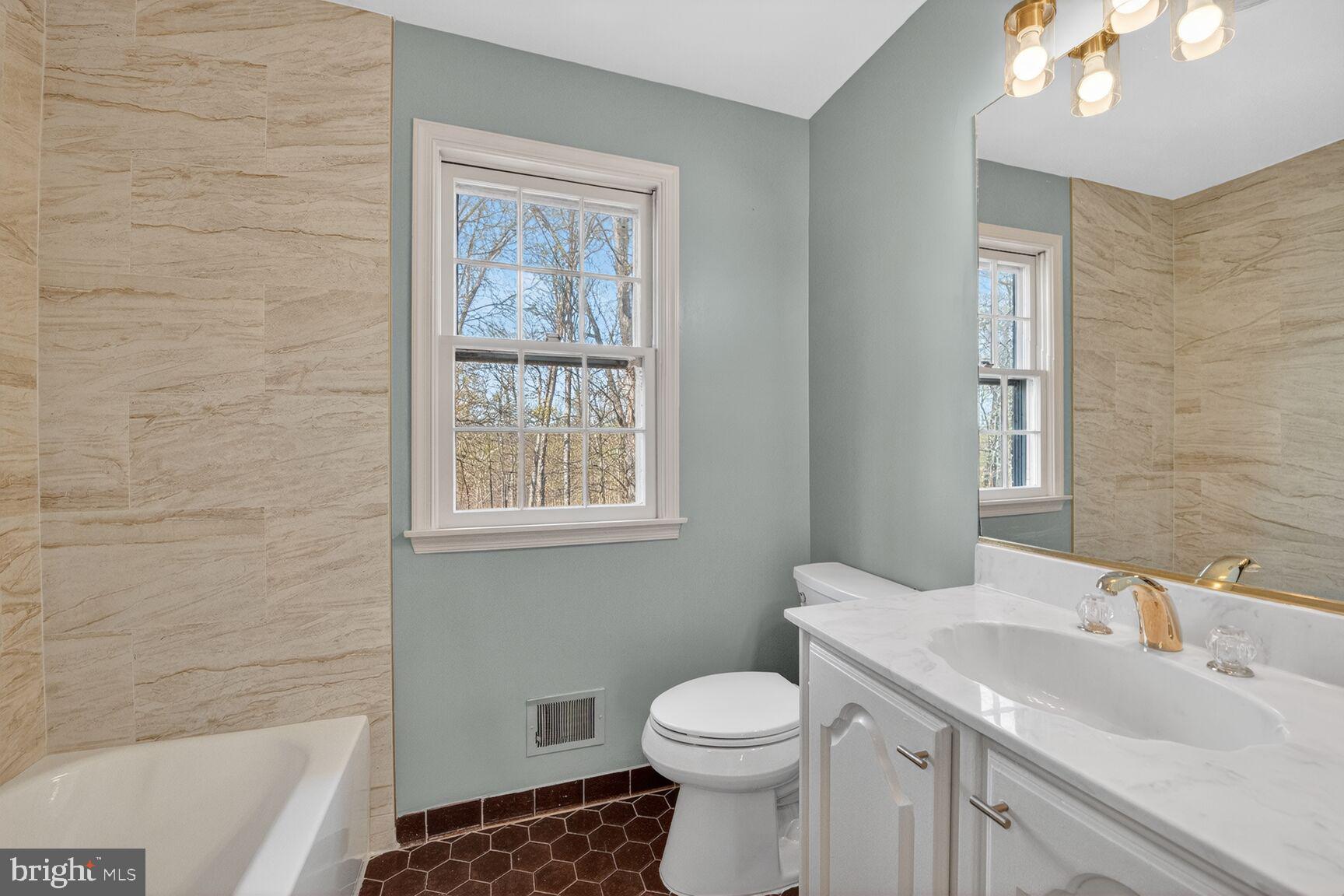 21733 Oatlands Road Aldie, VA 20105 - Photo 24 of 50 a bathroom with a sink toilet and shower