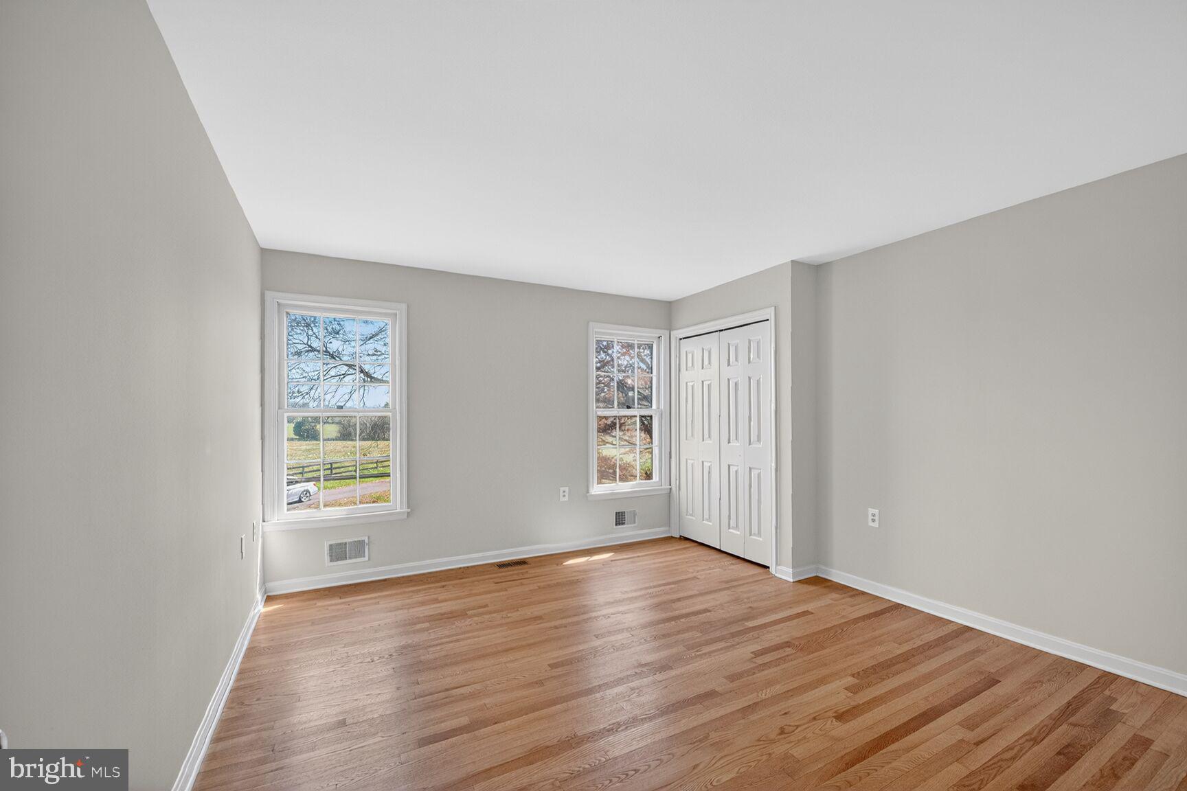 21733 Oatlands Road Aldie, VA 20105 - Photo 26 of 50 an empty room with wooden floor and windows