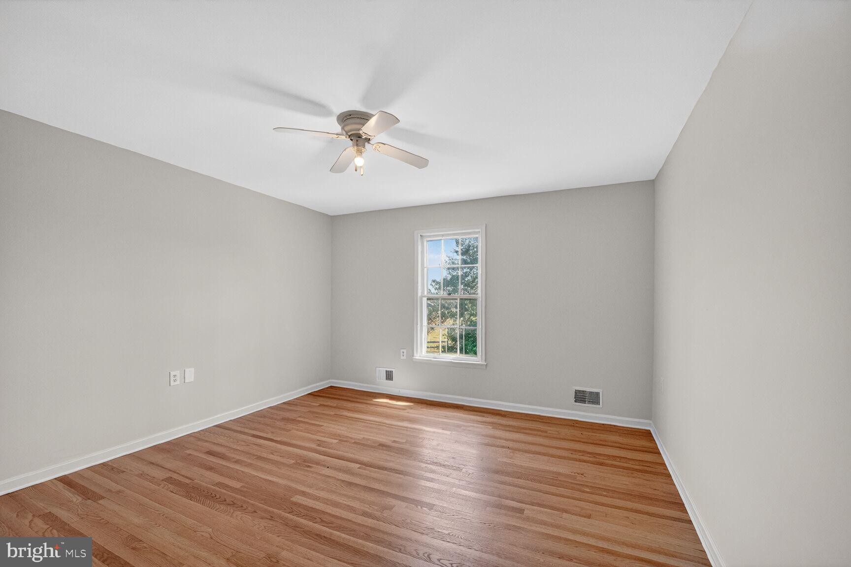 21733 Oatlands Road Aldie, VA 20105 - Photo 27 of 50 a view of empty room with wooden floor and fan