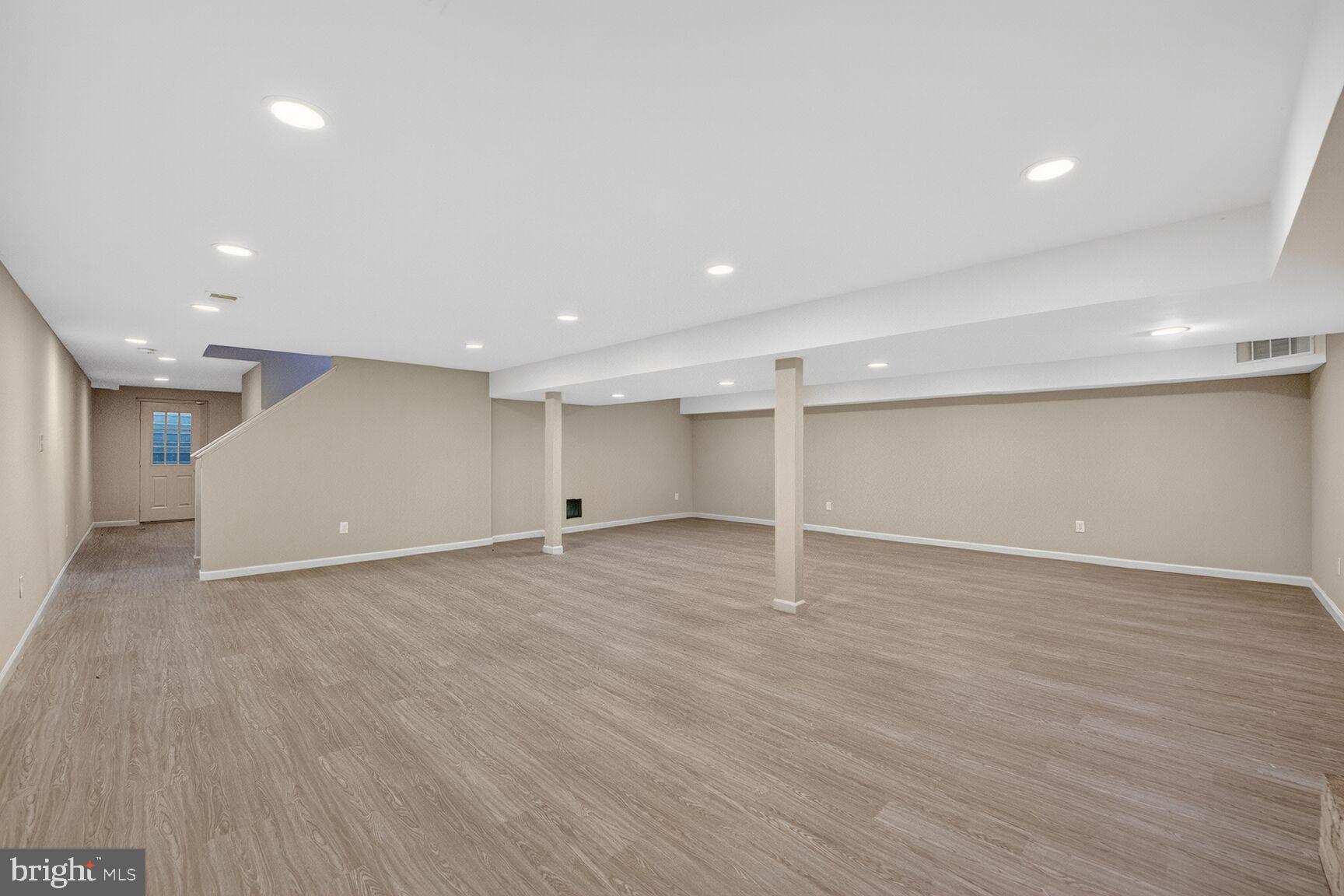 21733 Oatlands Road Aldie, VA 20105 - Photo 34 of 50 an empty room with wooden floor and windows