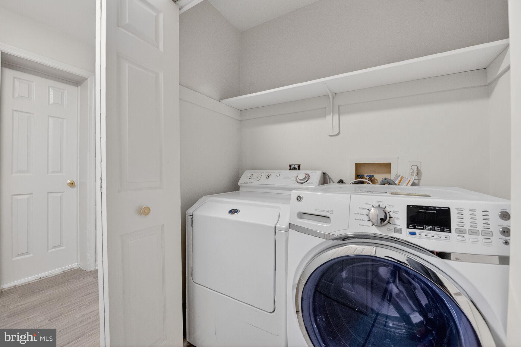 21733 Oatlands Road Aldie, VA 20105 - Photo 39 of 50 a view of washer and dryer with kitchen in the background