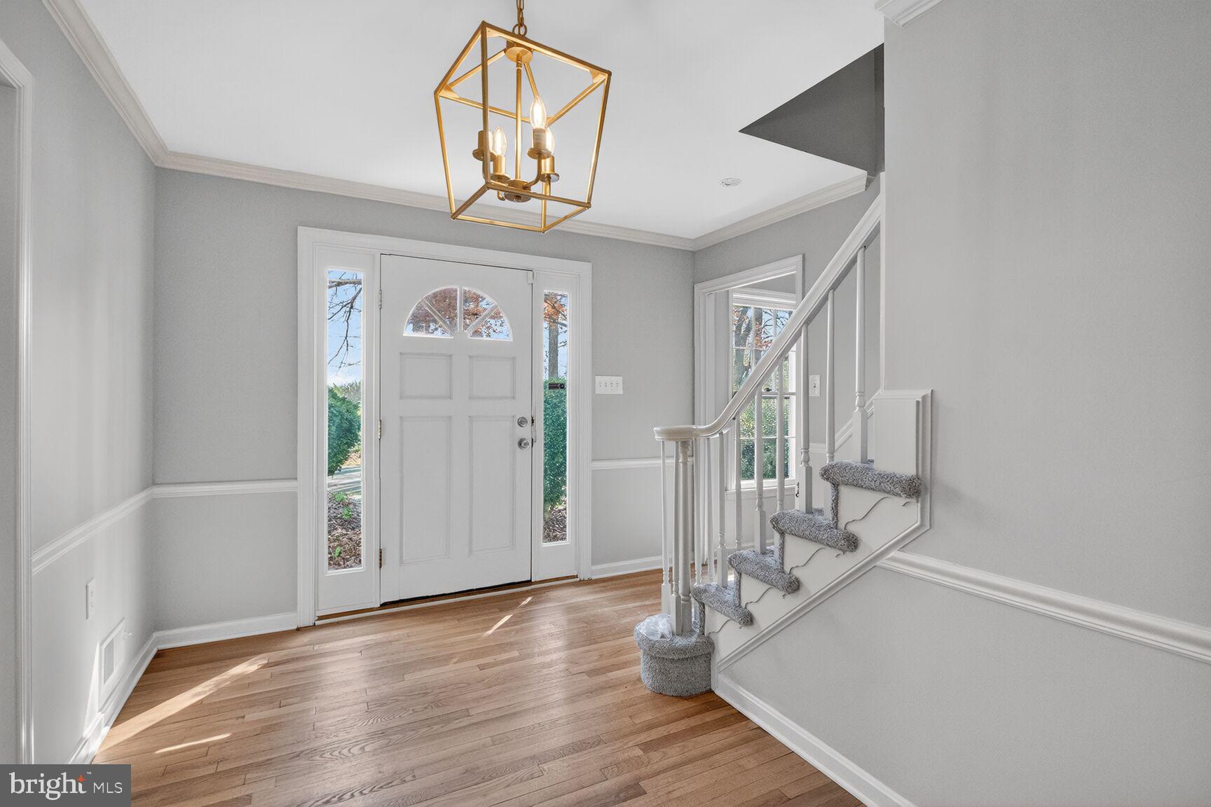 21733 Oatlands Road Aldie, VA 20105 - Photo 4 of 50 a view of a hallway with wooden floor and staircase