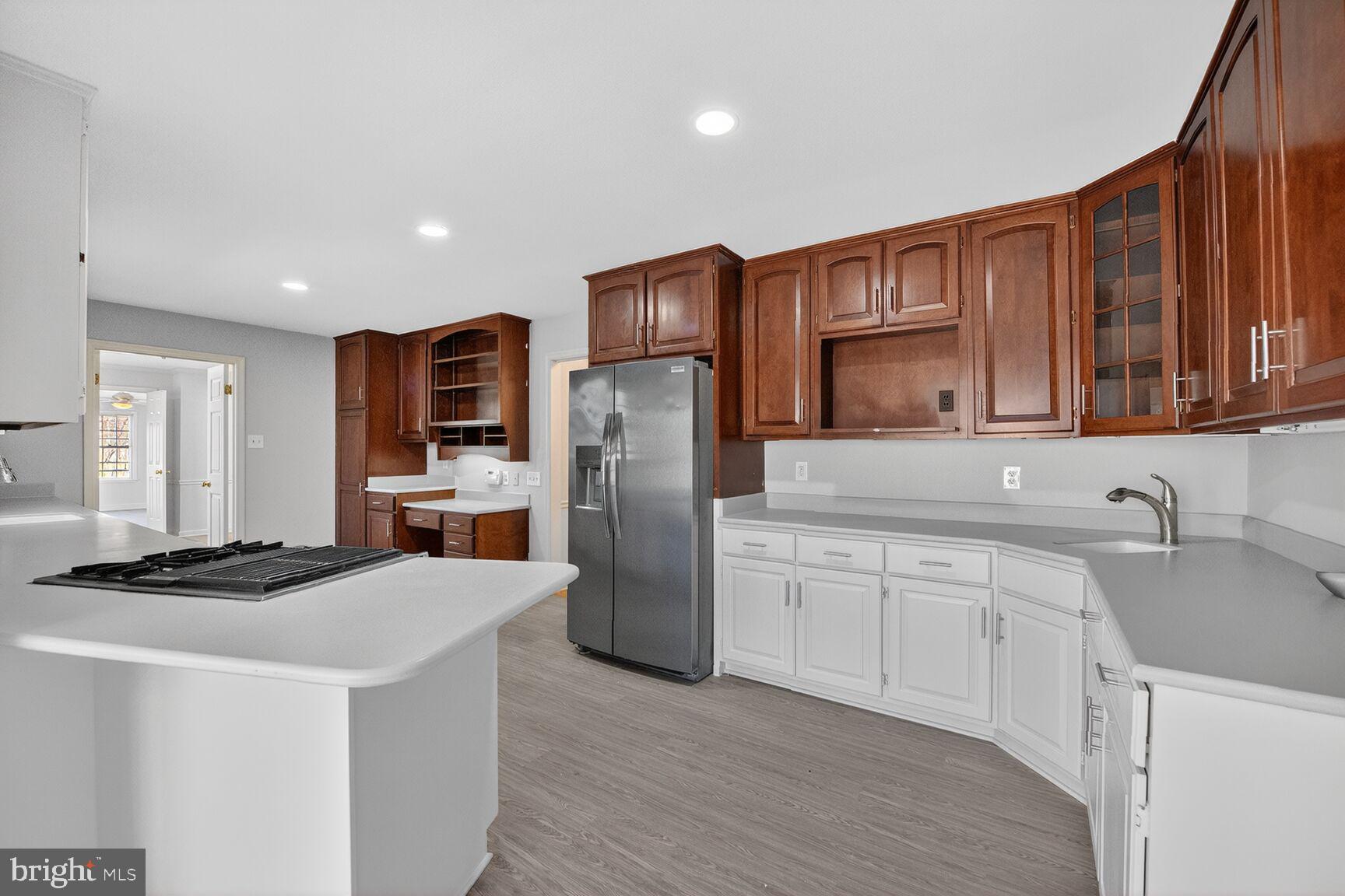 21733 Oatlands Road Aldie, VA 20105 - Photo 10 of 50 a kitchen with stainless steel appliances granite countertop a refrigerator sink and cabinets