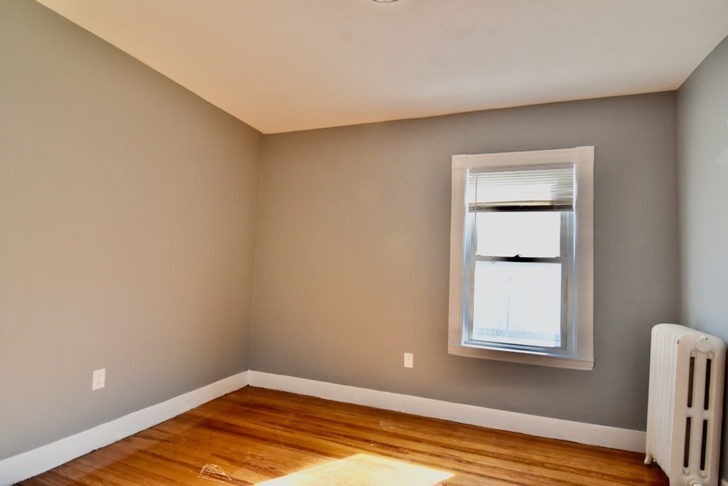 21 Treadway Road, Unit 2 Boston, MA 02125 - Photo 19 of 21 a view of a room with wooden floor and a window